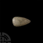 British Stone Axe. Neolithic, 3rd millennium B.C. B.C. A diorite axehead with lentoid section body. 148 grams, 94 mm (3 3/4 in.) H.C. Hosier Braeside,...
