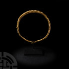 Viking Age Gold Twisted Bracelet. 9th-11th century A.D. A twisted gold bracelet composed of a tapering round-section body, one terminal formed as a lo...