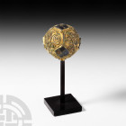 Anglo-Saxon Gilt-Bronze Pin Head with Garnets. 8th-9th century A.D. A large, gilt-bronze spherical pin head, richly ornamented with filigree scroll wo...