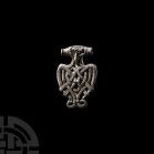 Viking Age Silver Filigree Zoomorphic Pendant. 9th-12th century A.D. A silver zoomorphic pendant in the form of a bird with wing and feather detailing...