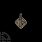 Viking Age Silver Filigree Pendant. 9th-11th century A.D. A silver lozengiform pendant decorated with a knotwork motif in filigree, suspension loop wi...