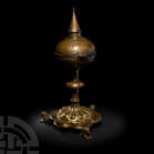 Medieval Lower Saxony Ciborium. c.1400 A.D. A gilt-bronze ciborium with hinged spherical body and conical finial imitating the spire of a church, trac...