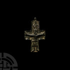 Byzantine Cross Pendant. 10th-12th century A.D. A bronze cruciform pendant with high-relief corpus christi to one face, impressed pellets flanking the...