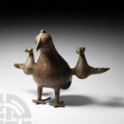 Bird Oil Lamp. 19th century A.D. or earlier. An oil lamp in the form of a stylised standing bird with outspread wings, each formed as a smaller bird a...
