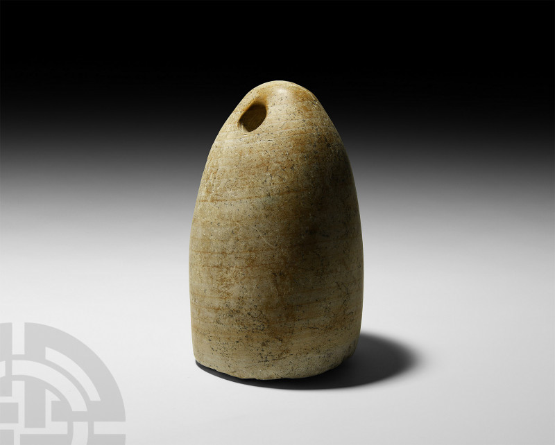 Bactrian Weight-Shaped Idol. 2nd millennium B.C. A carved limestone plano-convex...