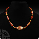 Carnelian and Gold Bead Necklace. Mainly 1st millennium B.C. A restrung designer necklace composed of graduated biconical and tubular carnelian beads,...