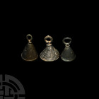 Amlash Bell Pendant Collection. 2nd-1st millennium B.C. A mixed group of three bell pendants with suspension loops above and bars or partial bars for ...