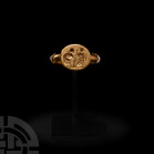 Gold Ring with Figure before Jesus. 19th century A.D. or earlier. A gold finger ring composed of a D-section hoop with oval bezel engraved with a figu...