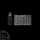 Large Western Asiatic Cylinder Seal Pendant. c.2nd millennium B.C. A black jasper cylinder seal pendant with roughly cylindrical body and integral sus...