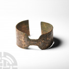 Bracelet with Engraved Design. 10th-8th century B.C. A penannular bracelet with broad arms and waisted central section, engraved with geometric motifs...