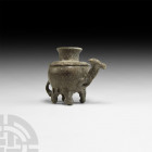 Glass Camel Vessel. 13th-14th century A.D. An opaque glass jar with bulbous body, crimped applied collar to the shoulder, flared spout, applied tail, ...