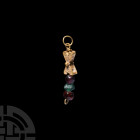 Gold and Gemstone Pendant. Early 1st millennium A.D. A pendant comprising a hollow-formed sheet gold saltire with granulation and pellet to one face a...