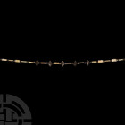 Elamite Bead Necklace with Silver Bulbs. 24th-21st century B.C. A necklace composed of silver biconvex and spherical beads, with notched shell or ston...