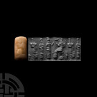 Mesopotamian Cylinder Seal with Worship Scene. 3rd-2nd millennium B.C. A chalcedony cylinder seal drilled for suspension, bearing a worshipping scene ...