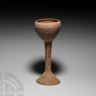 Bactrian Terracotta Chalice. 3rd millennium B.C. A ceramic chalice composed of a rounded conical bowl, tapering cylindrical stem and splayed ogival fo...