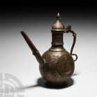 Ottoman Copper Ewer. Early 19th century A.D. A copper ewer with dense coverage of foliate designs and teardrop to centre, hinged ogival lid and taperi...