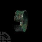 Hasanlu Decorated Bracelet. 9th century B.C. A hammered bronze penannular bracelet, the surface decorated with chased geometric patterns of circles al...