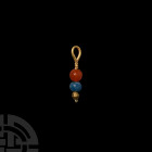 Gold Pendant with Beads. 1st millennium B.C. A gold pendant comprising a round-section loop, slender stem with bulbous collar ornamented with filigree...