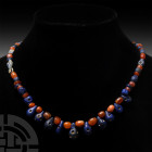 Mesopotamian Stone Bead Necklace. 3rd-2nd millennium B.C. A restrung necklace composed of graduated blue and red stone beads, including annular, facet...