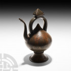 Mamluk Style Engraved Brass Kettle. Late 19th-20th century A.D. A drop-form kettle on a splayed ogival foot, facetted handle with hinged pyramidal inl...