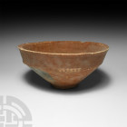 Holy Land Decorated Terracotta Bowl. 3000-2700 B.C. A terracotta bowl with carinated body, everted rim, shallow foot and decorative strips of pellets ...
