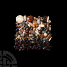 Stone Bead and Pendant Collection. 1st millennium B.C. and later. A large group of stone beads and pendants comprising: a group of rough and polished ...