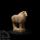South Arabian Alabaster Bull. c.1st-3rd century A.D. An alabaster bull carved in the round standing on a rectangular plinth, with exaggerated stocky s...