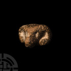 Ram's Head Finial. 2nd-1st millennium B.C. A carved stone ram's head modelled with curled horns, shallow recessed eyes and rounded muzzle, circular so...