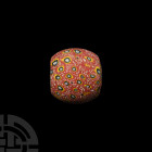 Mosaic Glass Bead. 20th century A.D. A barrel-shaped mosaic glass bead with red, yellow, white and other colours. 36 grams, 30 mm (1 1/8 in.) London c...