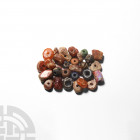 Mesopotamian Amber Bead Necklace. 2nd millennium B.C. A mixed group of over thirty beads comprising various types in amber and glass, including exampl...