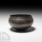 Silver Bowl with Animals and Calligraphy. 19th century A.D. A carinated silver bowl decorated with circumferential bands of lozenges, floral vines, ca...