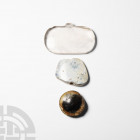 Bead and Pendant Collection. 19th century A.D. and earlier. A group of two beads and a pendant comprising smoky quartz, agate and composition examples...