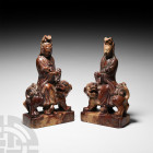 Chinese Kuan-Yin Seated on Temple Lion-Dog Pair. Late 19th-early 20th century A.D. A matched pair of carved rhyolite figurines of the bodhisattva Kuan...