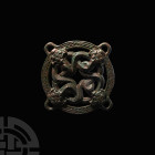 Chinese Ordos Dragon Belt Distributor. 6th-2nd century B.C. or later. A belt distributor composed of an openwork discoid body, four lugs to the perime...