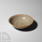 Chinese Song Glazed Bowl. Song Dynasty, 960-1279 A.D. A pale blue-green glazed ceramic bowl with everted rim and shallow foot. 195 grams, 15.4 cm wide...