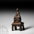 Sino-Tibetan Gilt Seated Shakyamuni Figurine. 19th century A.D. A gilt-bronze figure of Shakyamuni seated with hands folded across the midriff, restin...