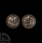 Chinese Dragon Disc Pair. 19th century A.D. A matched pair of white metal discs, each with repoussé winged dragons framed by pellets, scrolls in field...