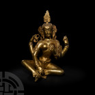 Sino-Tibetan Gilt Seated Avalokiteshvara. 19th-20th century A.D. A gilt-bronze figurine of Avalokiteshvara sitting cross-legged, two arms held in fron...