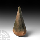 Large Thai Teardrop-Shaped Green Glass Ingot. 1st century B.C.-4th century A.D. A substantial green glass ingot, triangular in plan with rounded butt....