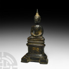 Thai Gilt Seated Buddha. 19th-20th century A.D. A gilt-bronze statuette of Buddha sitting cross-legged on a raised dais resting on a D-shaped base; Bu...