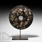 Very Large Chinese Bi Disc. 20th century A.D. or earlier. A very large stone bi disc mounted on a custom-made display stand. 2.22 kg total, 41 cm high...