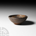 Chinese Song Tea Bowl. Song Dynasty, 960-1279 A.D. A miniature ceramic bowl with D-section conical body, the interior and upper body with glaze. 105 g...