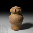 Indus Valley Cylindrical Fertility Figure. c.3300-1300 B.C. A bell-shaped ceramic fertility figure with squat, bulbous head, stylised face composed of...