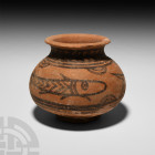 Indus Valley Mehrgarh Vessel with Fish. 3rd millennium B.C. A ceramic vessel composed of a carinated body, broad neck, everted rim and discoid foot, p...