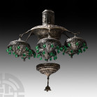Indian Chandelier Fitting Group. 20th century A.D. A group of base metal fittings with repoussé ornament for a chandelier comprising a hub with column...