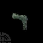 Socketted War Hammer. 2nd millennium B.C. A socketted war hammer composed of a tapering lentoid-section head, curving to a hollow shank with four circ...