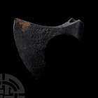 Viking Age Bearded Axehead. 9th-11th century A.D. An iron axehead with curved blade and chin to the lower edge, round socket with lateral triangular f...