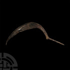 Viking Age Tanged Scythe. 9th-11th century A.D. An iron scythe composed of a curved blade with remains of teeth towards the tip and integral tapering ...