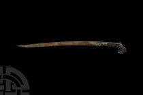 Ottoman Yataghan Sabre with Silver Qur'anic Inscription. 18th century A.D. A hammer-welded single-edged blade with swept profile, cast guard with saw-...