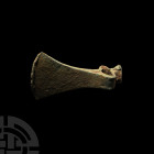 Socketted Axehead. Late 3rd millennium B.C. A large heavy socketted hammer axe having trapezoidal blade, flanged neck and cylindrical hammer; both the...